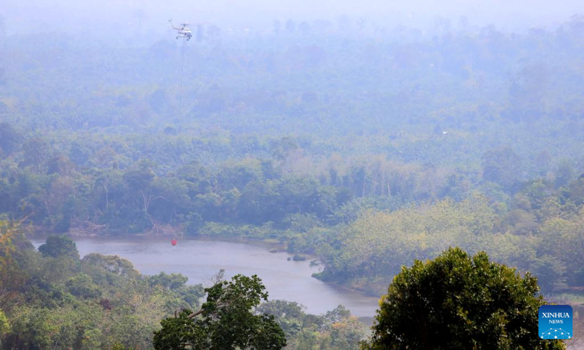 A water bombing helicopter tries to extinguish a forest and land fire at Rokan Hulu regency in Riau province, Indonesia on July 24, 2025. Indonesian authorities were accelerating efforts to tackle forest and land fires, particularly in Riau province and other regions across Sumatra Island in the country's western territories. According to the Coordinating Ministry for Political and Security Affairs, a spike in hotspots was detected in Riau between July 19 and 20, with smoke potentially drifting to neighboring countries. (Indonesia's National Disaster And Mitigation Agency/Handout via Xinhua)