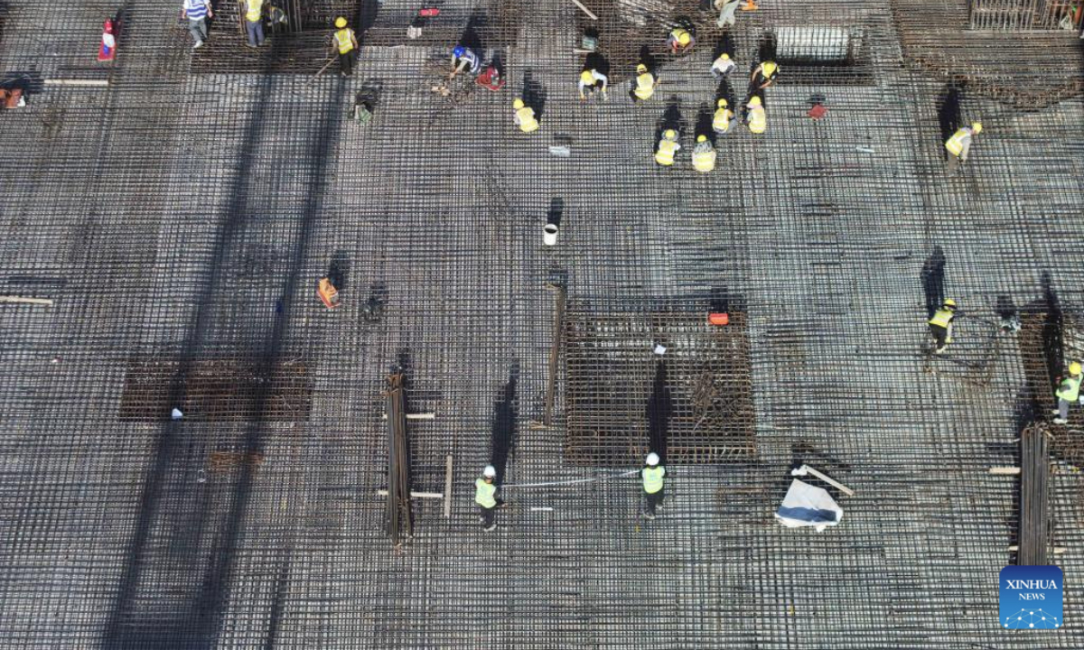 An aerial drone photo shows workers working at the construction site of the Nantong Railway Station in Nantong, east China's Jiangsu Province, July 21, 2025. The station is along a high-speed railway linking Shanghai, Nanjing of Jiangsu Province and Hefei of Anhui Province in east China. (Xinhua/Ji Chunpeng)