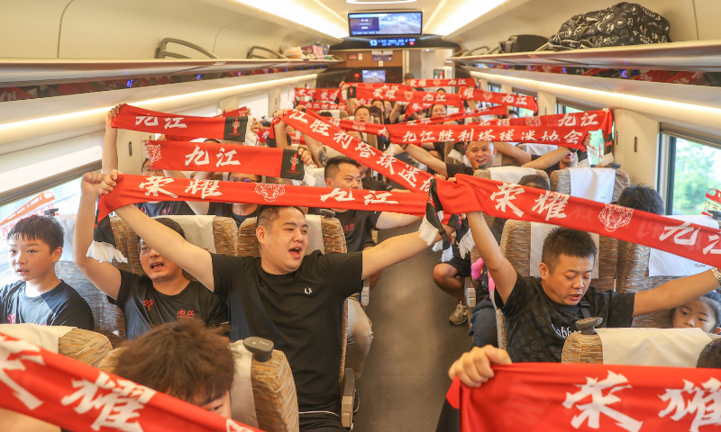 Supporters of the Jiujiang Team practice cheering movements and slogans on the G9813/2 train, which departs from Lushan Station in Jiujiang, East China's Jiangxi Province, on August 2, 2025. It is a fan-only railway express, specially designed for football fans of the 2025 Jiangxi Provincial Urban Football Super League, or Gan Super League. Photo: VCG