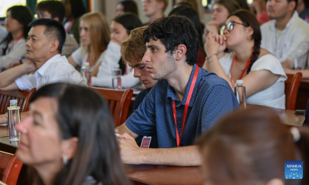Members of a U.S. delegation watch a documentary titled Touching the Tigers in Hong'an County, central China's Hubei Province, July 28, 2025. A delegation of descendants of U.S. Flying Tigers veterans, and students and teachers from several Flying Tigers friendship schools, led by Jeffrey Greene, chairman of the Sino-American Aviation Heritage Foundation, visited Hubei from July 26 to 30. (Xinhua/Du Zixuan)