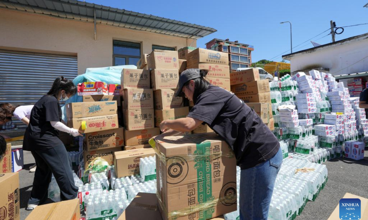 Staff members pack relief supplies at Xizhuangzi Village of Fengjiayu Town, Miyun District of Beijing, capital of China, July 30, 2025. Due to continuous heavy rainfall in recent days, hundreds of villages in multiple districts of Beijing have been affected. In some villages of Fengjiayu Town, Miyun District, the roads have not yet been restored. Relevant departments have organized multiple rescue forces including firefighters and militiamen to transport relief supplies on foot to the villages to ensure the living needs of the affected villagers. (Xinhua)
