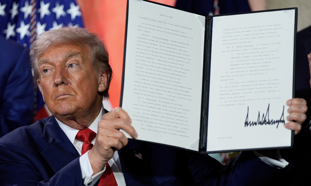 President Donald Trump holds a signed executive order regarding permitting for AI infrastructure after speaking during an AI summit at the Andrew W. Mellon Auditorium, Wednesday, July 23, 2025, in Washington.?Photo: VCG