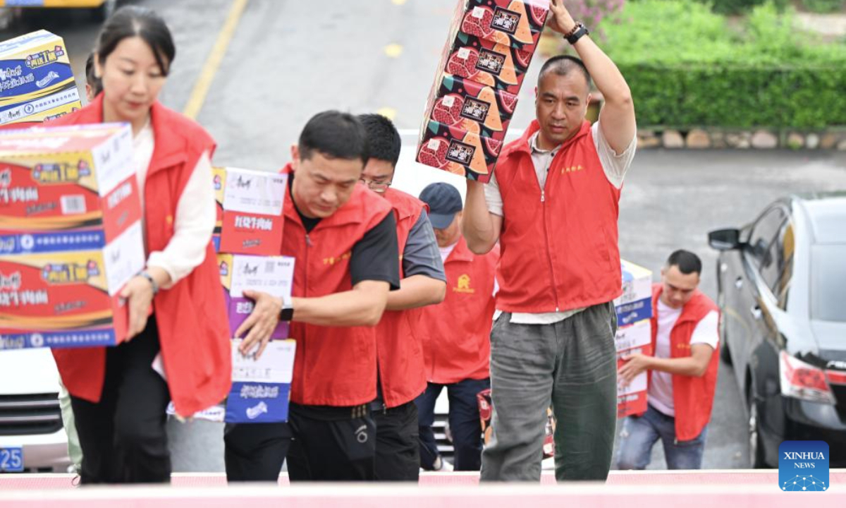 Volunteers deliver disaster relief supplies at a school-turned relocation site in Xiaying Town, Jizhou District of north China's Tianjin, July 28, 2025. Houses, bridges and power lines at part of villages in Jizhou District were damaged by floods inflicted by recent heavy rainfall and upstream runoff.

Local emergency operations including search and rescue, evacuee transfer, and disaster relief are orderly going on. (Xinhua/Li Ran)