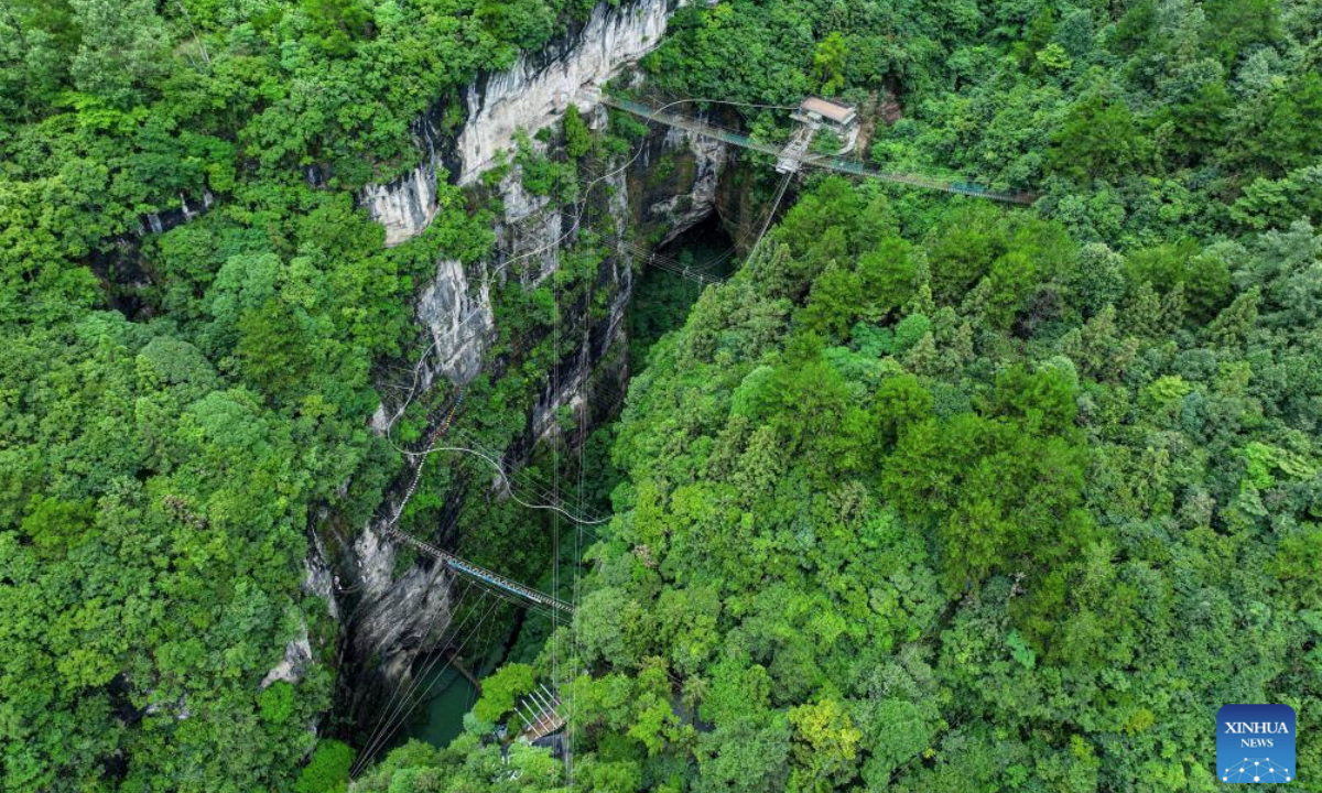 An aerial drone photo taken on July 22, 2025 shows a panoramic view of a giant sinkhole in Kaiyang County, southwest China's Guizhou Province. Guizhou Province is renowned for its extensive karst landscape, which is distinguished by its numerous giant sinkholes, locally called tiankeng or heavenly pits. The natural sinkholes are increasingly recognized for their unique tourism values. (Xinhua/Ou Dongqu)