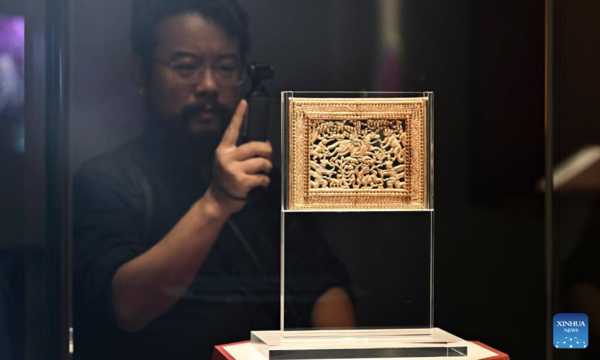 A media worker takes photos of an exhibit during a cultural relic exhibition at the Shanghai Museum East in east China's Shanghai, July 8, 2025. The exhibition, featuring over 300 cultural relics from Guyuan City of northwest China's Ningxia Hui Autonomous Region, opened in Shanghai on Tuesday. (Xinhua/Chen Haoming)