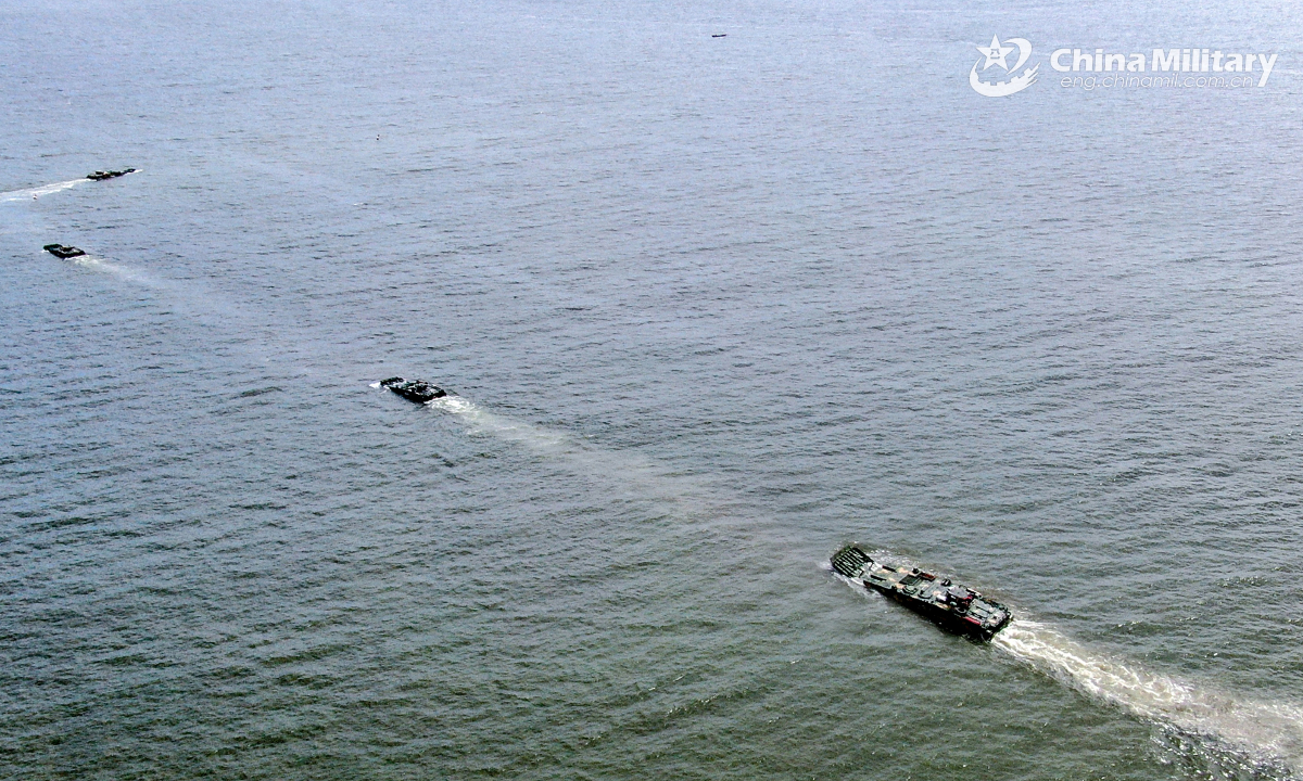 Amphibious armored infantry fighting vehicles (IFV) attached to a brigade with the Chinese PLA Army maneuver towards the designated area during a ferrying and assault wave formation training exercise on July 6, 2025. (eng.chinamil.com.cn/Photo by Zhang Mao)