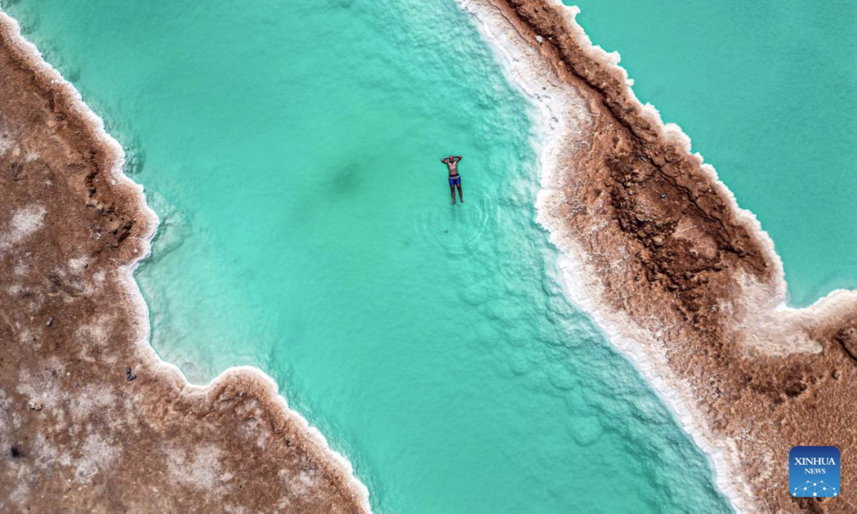 An aerial drone photo taken on July 28, 2025 shows tourists floating on a salt lake at Siwa Oasis in Matrouh Governorate, Egypt. Siwa Oasis lies in Egypt's western desert, some 800 kilometers from Cairo. There are many natural salt lakes on which people can float with no effort due to high salt concentration. (Xinhua/Ahmed Gomaa)