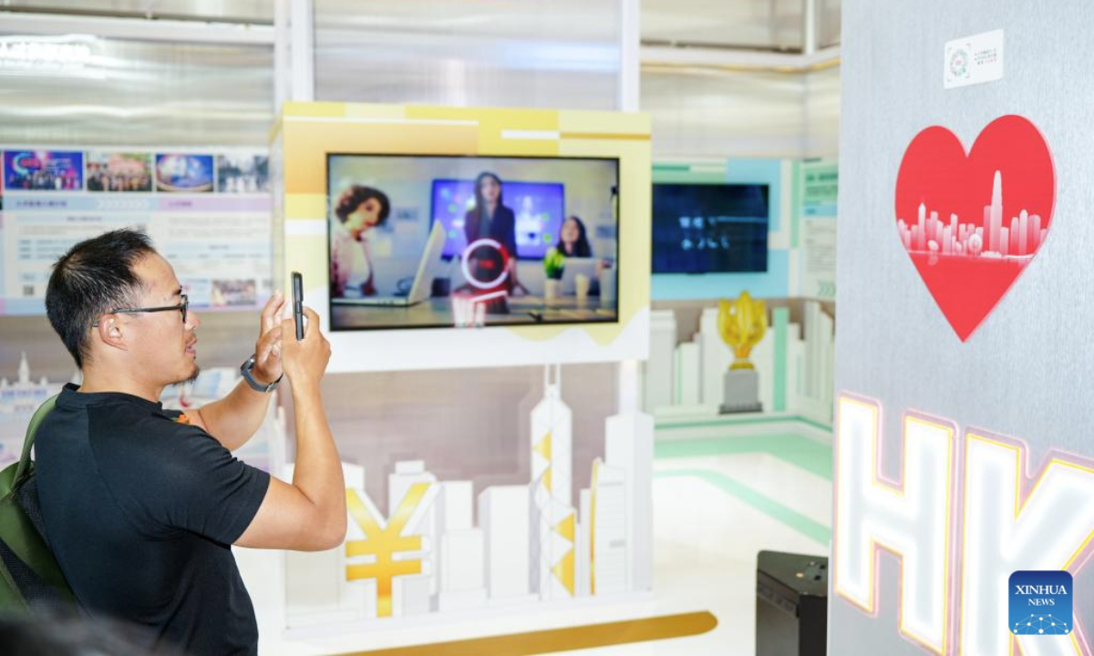 A visitor takes a photo at a Hong Kong-themed exhibition in Urumqi, northwest China's Xinjiang Uygur Autonomous Region, July 28, 2025. The exhibition kicked off here on Monday. (Xinhua/Xu Hongyan)