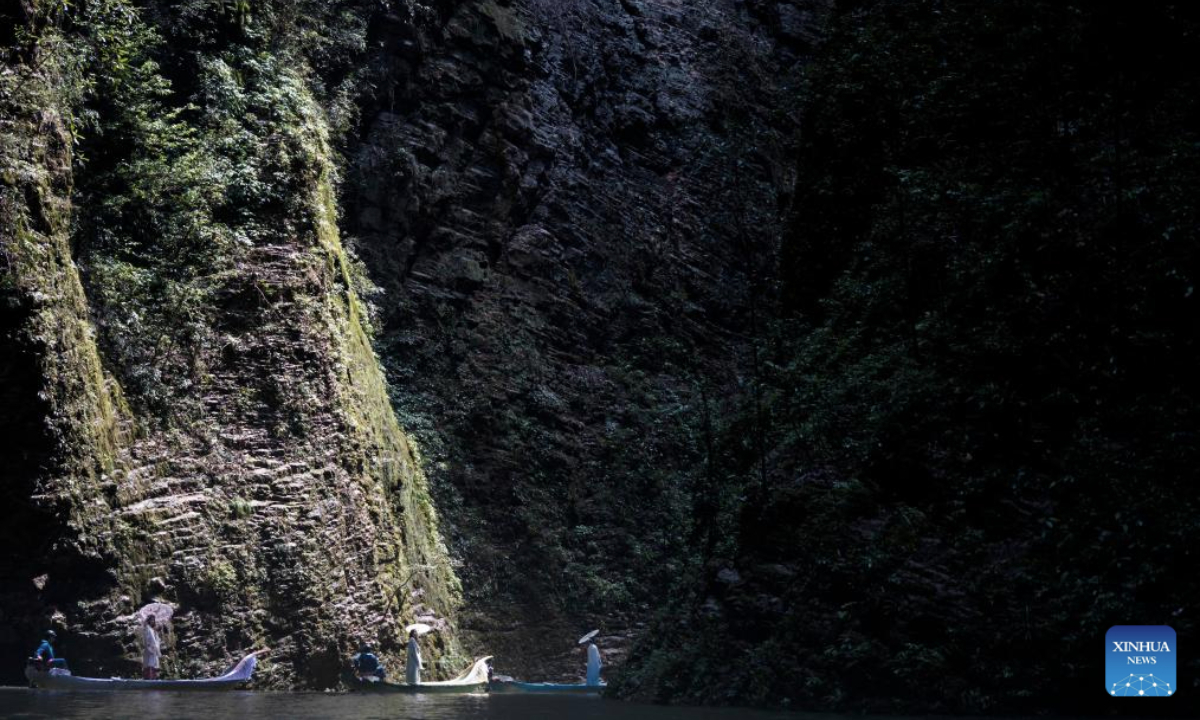 Tourists take boats enjoying the view of Pingshan canyon in Hefeng County, Enshi Tujia and Miao Autonomous Prefecture, central China's Hubei Province, July 9, 2025. The unique canyon landscape and limpid water make the Pingshan Canyon an attractive destination for tourists. (Xinhua/Wu Zhizun)