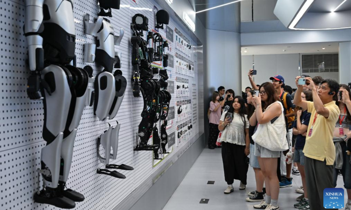 Members of a U.S. delegation visit an innovation center of humanoid robot in Wuhan City, central China's Hubei Province, July 29, 2025. A delegation of descendants of U.S. Flying Tigers veterans, and students and teachers from several Flying Tigers friendship schools, led by Jeffrey Greene, chairman of the Sino-American Aviation Heritage Foundation, visited Hubei from July 26 to 30. (Xinhua/Du Zixuan)