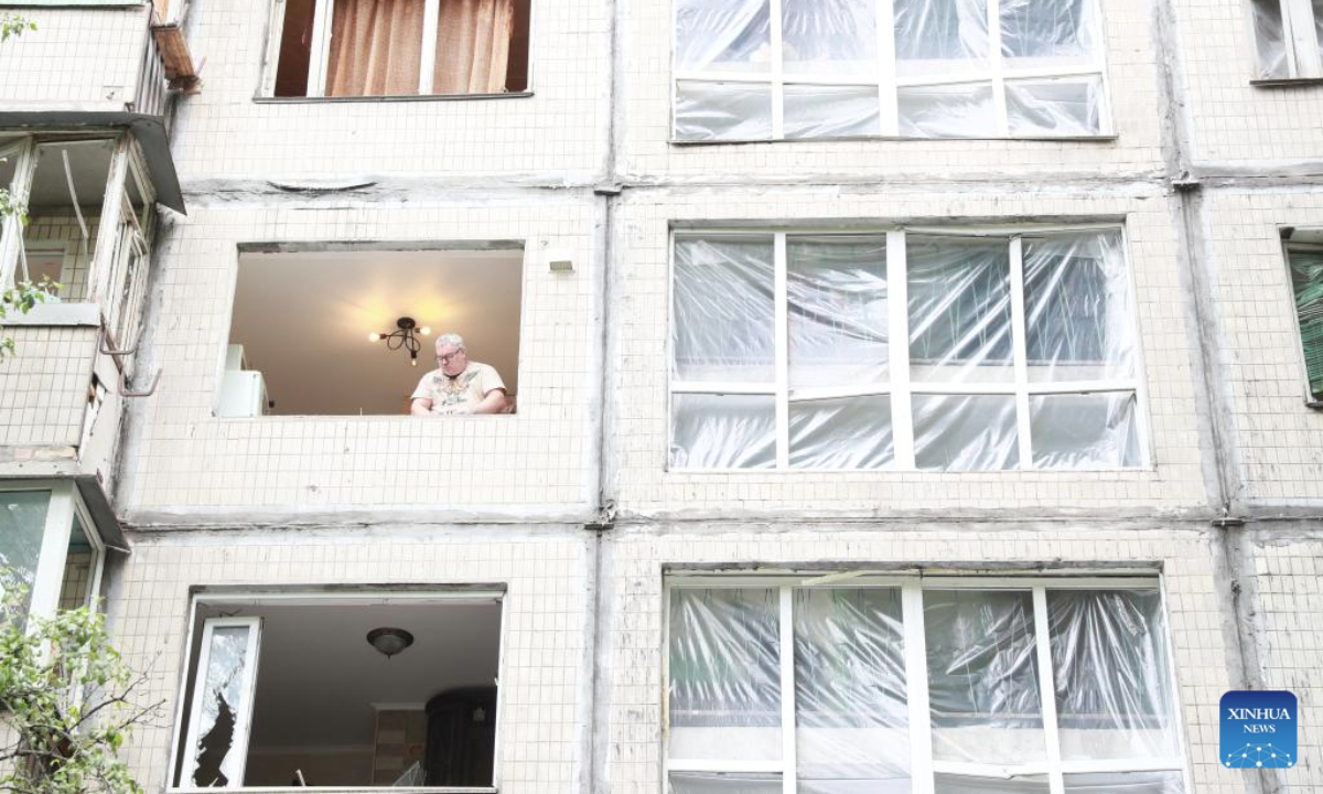 A man is seen inside a residential building damaged in a Russian attack in the Sviatoshinskyi District of Kiev, Ukraine, on July 31, 2025. (Xinhua/Li Dongxu)