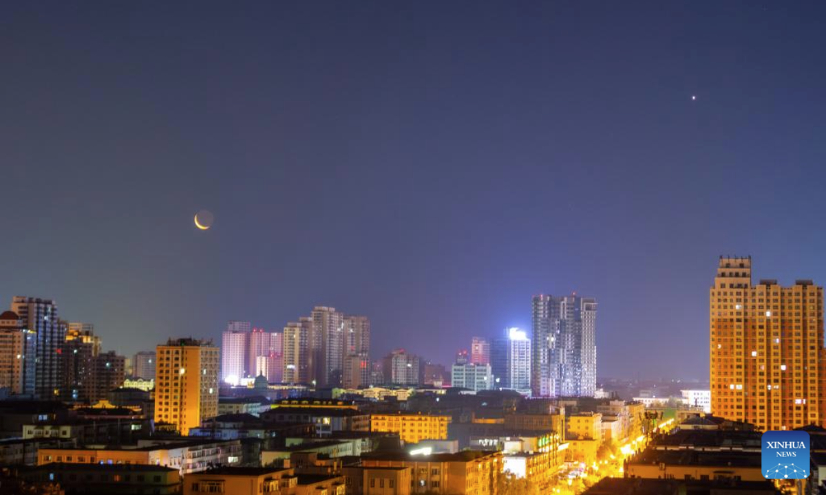 A view of the Venus at its greatest annual altitude is pictured next to a crescent moon in Jiamusi City, northeast China's Heilongjiang Province, July 23, 2025. (Photo by Chen Zhiguo/Xinhua)