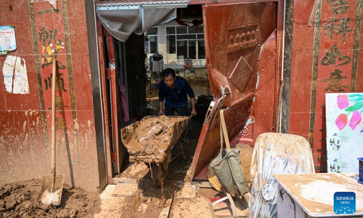 A villager cleans up silt in Liudaogou Village in Liudaohe Town, Xinglong County of north China's Hebei Province, Aug. 1, 2025. Affected by heavy rainfall, some roads and houses were damaged in several villages in Liudaohe Town. In recent days, local authorities have actively organized efforts to carry out relief operations to restore roads, power supply, and communication facilities, along with environmental disinfection measures. (Photo by Wang Liqun/Xinhua)