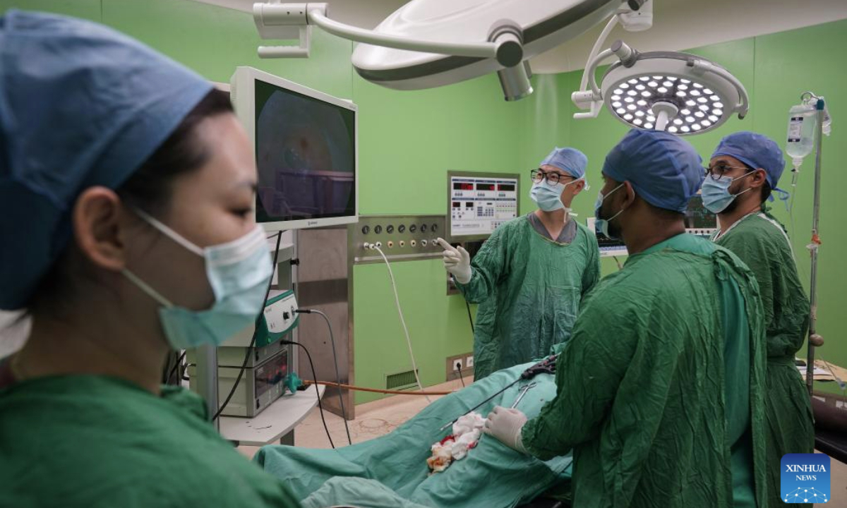 Doctor Lyu Jiayu (2nd L) and nurse Liu Huichao (1st L), who are members on the 35th Chinese medical team to Mauritania, cooperate with local doctors during a surgery at the Friendship Hospital in Nouakchott, Mauritania, on July 14, 2025. Since 1968, China has sent 35 batches of medical teams to Mauritania with more than 800 medical workers involved. The 35th Chinese medical team, consisting of 21 members, arrived in Mauritania in May 2023. (Xinhua/Han Xu)