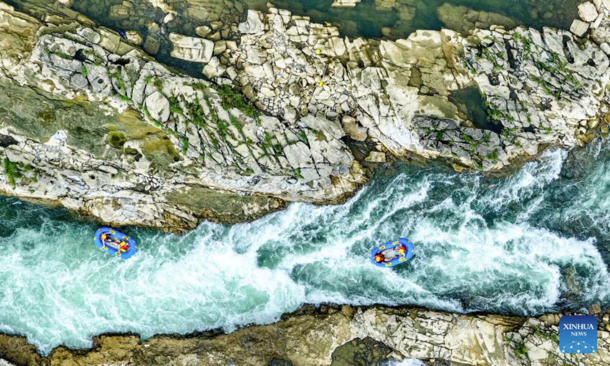 An aerial drone photo taken on July 21, 2025 shows people rafting in inflatable boats on Luobei River in Guiding County, southwest China's Guizhou Province. (Xinhua/Ou Dongqu)