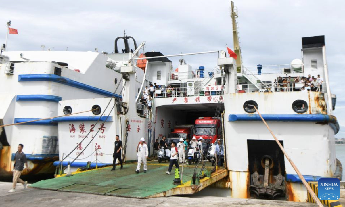 Passengers disembark from a ferry ship at Xiuying Port in Haikou, south China's Hainan Province, July 22, 2025. The passenger and freight ferry service in the Qiongzhou Strait has been resumed in an orderly manner as the impact of Typhoon Wipha weakens. (Xinhua/Yang Guanyu)