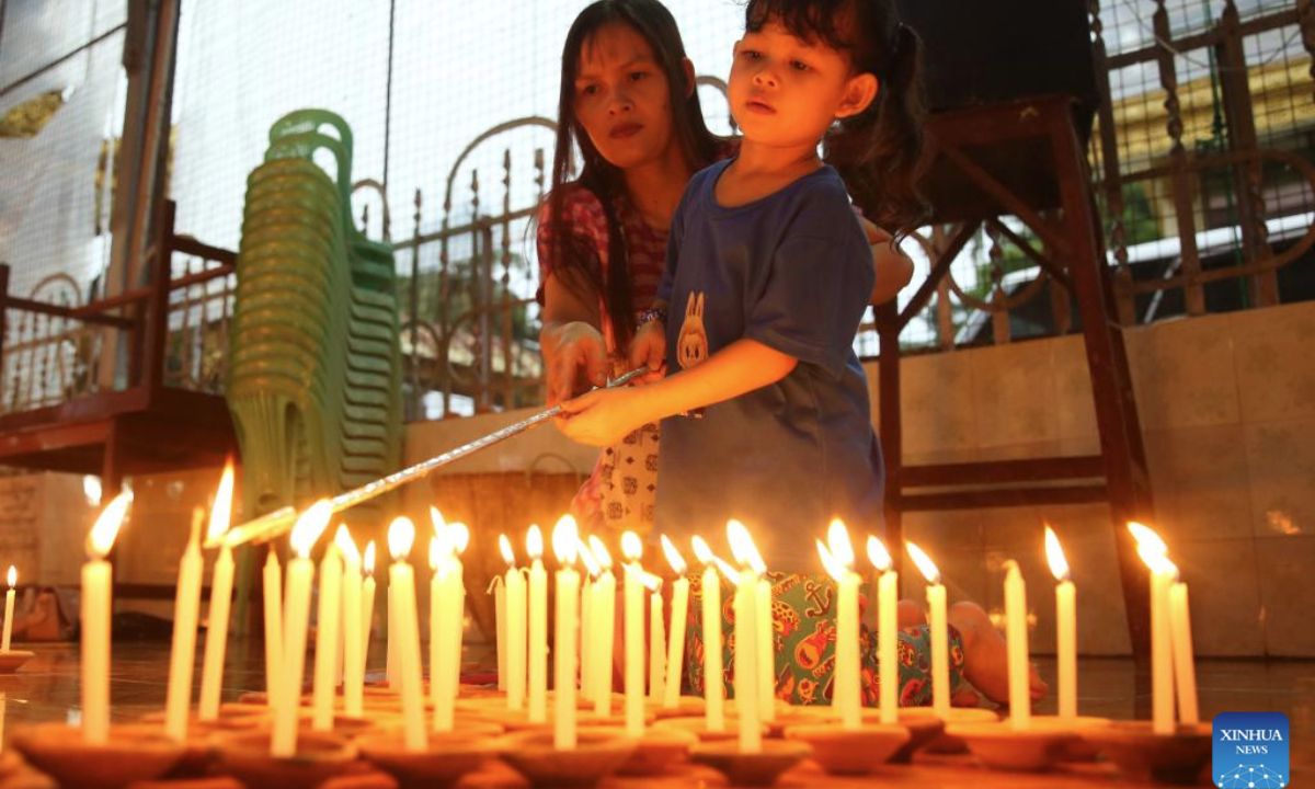 People light candles during celebrations of the full moon day of Warso, the fourth month of Myanmar calendar, at the Koe Htat Gyi Pagoda in Yangon, Myanmar, July 9, 2025. (Xinhua/Myo Kyaw Soe)
