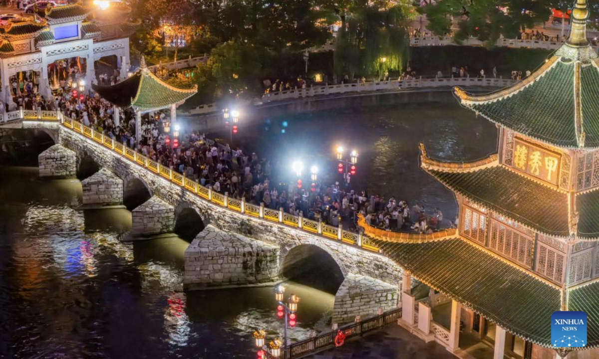 An aerial drone photo taken on July 30, 2025 shows people visiting Jiaxiu tower scenic area in Guiyang, capital of southwest China's Guizhou Province. Guizhou Province, with its cool climate and rich tourism resources, attracts tourists from all over the country during the peak summer travel season. (Xinhua/Liu Xu)
