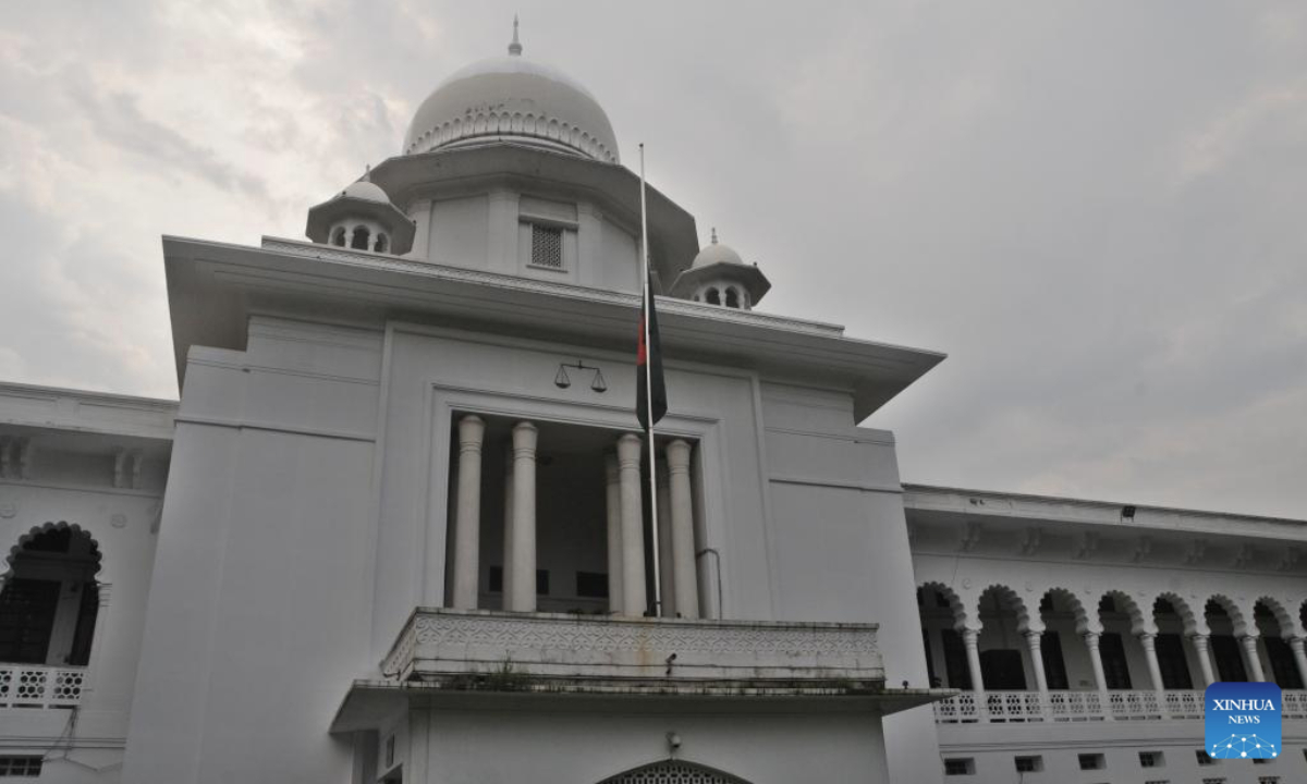This photo taken on July 22, 2025 shows a Bangladeshi national flag lowered to half-mast outside the Supreme Court of Bangladesh in Dhaka, Bangladesh. The death toll from Monday's crash of a Bangladesh Air Force training aircraft hit 31 on Tuesday, the Inter Service Public Relations (ISPR) of the Bangladesh Army said in a statement. The Bangladeshi government is observing a national day of mourning on Tuesday following the jet crash. As part of marking the day, the national flags have been flown at half-mast at all government, semi-government, autonomous bodies, and educational institutions across the country, as well as at Bangladeshi missions overseas. (Photo by Habibur Rahman/Xinhua)