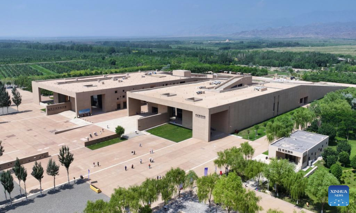 An aerial drone photo taken on July 13, 2025 shows tourists visiting the Xixia Imperial Tombs archaeological site park in Yinchuan, northwest China's Ningxia Hui Autonomous Region. China's Xixia Imperial Tombs were officially added to the UNESCO World Heritage List on Friday during the 47th session of the World Heritage Committee held in Paris, France. (Photo by Yuan Hongyan/Xinhua)
