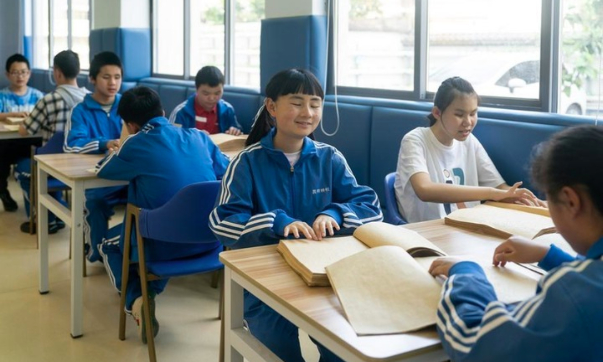 Visually impaired students read books at a reading room in the Kunming school for visually impaired and nonspeaking people in southwest China's Yunnan Province, April 15, 2024. (All photos were taken with consent of the subjects or their guardians.) (Xinhua/Chen Xinbo)