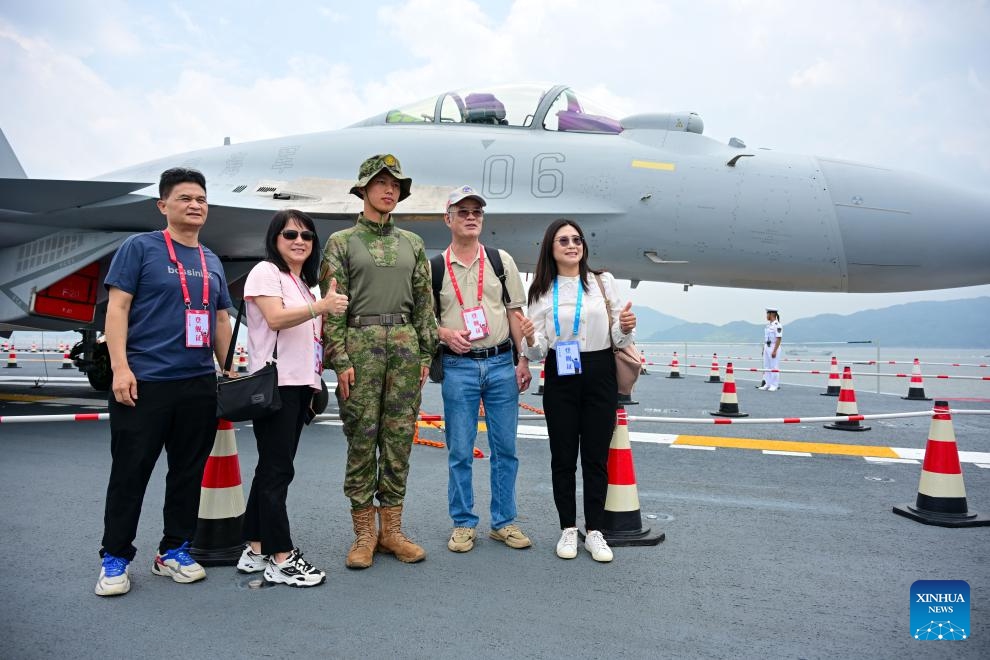 Visitors pose for a photo on the aircraft carrier Shandong in Hong Kong, south China, July 5, 2025. Hong Kong celebrated the 28th anniversary of its return to the motherland with a significant visit from a fleet of the Chinese People's Liberation Army Navy, led by China's first homegrown aircraft carrier Shandong. (Photo: Xinhua)