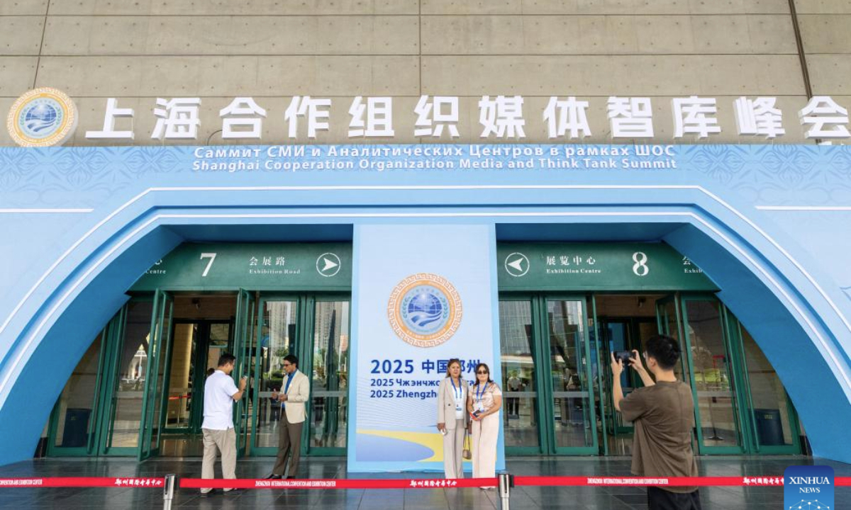 Participants of the Shanghai Cooperation Organization (SCO) Media and Think Tank Summit pose for photos outside the venue in Zhengzhou, central China's Henan Province, July 24, 2025. Themed Upholding the 'Shanghai Spirit' to Build a More Beautiful Home, the SCO Media and Think Tank Summit is held here from July 23 to 27. (Xinhua/Wu Jingdan)