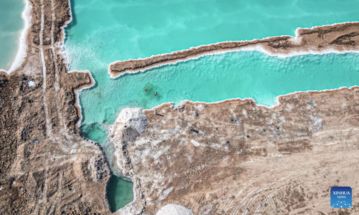 An aerial drone photo taken on July 28, 2025 shows tourists floating on a salt lake at Siwa Oasis in Matrouh Governorate, Egypt. Siwa Oasis lies in Egypt's western desert, some 800 kilometers from Cairo. There are many natural salt lakes on which people can float with no effort due to high salt concentration. (Xinhua/Ahmed Gomaa)