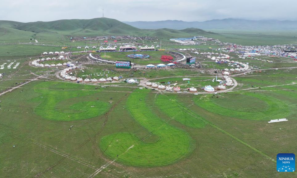 An aerial drone photo taken on July 19, 2025 shows the opening ceremony of a Nadam fair held in Xilinhot, Xilin Gol League, north China's Inner Mongolia Autonomous Region. The Nadam Fair opened here on Saturday, featuring night parade performances, intangible cultural heritage handicraft making events, and ethnic game experiences. The fair has effectively invigorated the summer tourism market, and attracted tourists to experience the charm of grassland culture. (Xilin Gol League Integrated Media Center/Handout via Xinhua)