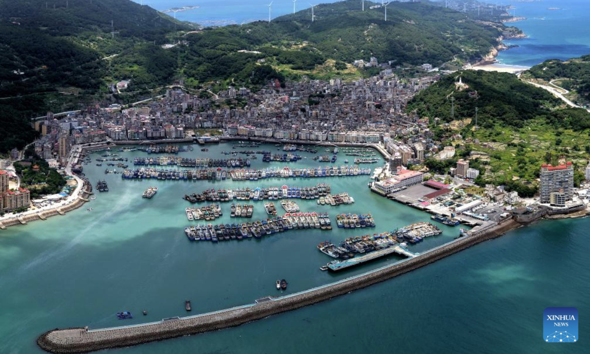This aerial drone photo taken on July 6, 2025 shows vessels mooring at a port to shelter from an approaching typhoon in Fuzhou, southeast China's Fujian Province. China's Ministry of Water Resources on Monday activated a Level-IV emergency response to flooding in the eastern provinces of Zhejiang and Fujian as Typhoon Danas approaches. (Photo by Wang Wangwang/Xinhua)