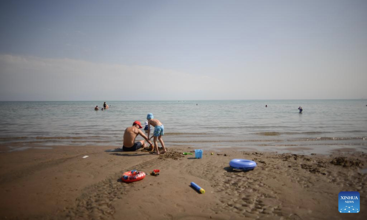 People visit the Kapchagay Reservoir in Konaev, Almaty region, Kazakhstan on July 26, 2025. Recently, the southern part of Kazakhstan, including the city of Almaty, Almaty region and South Kazakhstan region, has been hit by high heat waves. (Xinhua/Li Renzi)