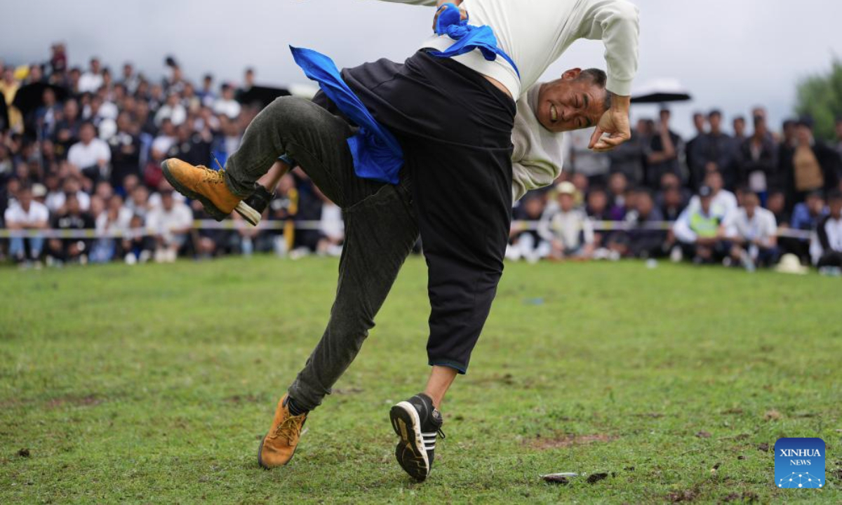 People wrestle during a torch festival in Longtan Township, Butuo County, southwest China's Sichuan Province, July 21, 2025. A traditional torch festival of Yi ethnic group was staged from July 21 to 23 here, which featured various activities including costume displays, campfire party, traditional ethnic sports events, dancing and traditional beauty contest to attract visitors from across the country. (Xinhua/Jiang Hongjing)