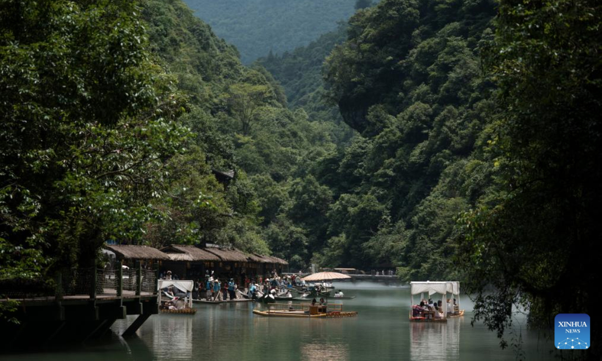 Tourists take boats enjoying the view of Pingshan canyon in Hefeng County, Enshi Tujia and Miao Autonomous Prefecture, central China's Hubei Province, July 9, 2025. The unique canyon landscape and limpid water make the Pingshan Canyon an attractive destination for tourists. (Xinhua/Wu Zhizun)