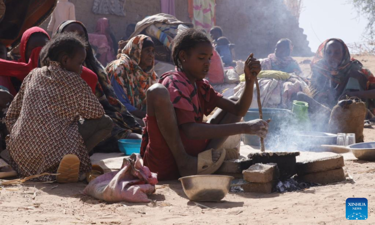 A girl prepares food at a displacement camp in El Fasher, North Darfur region, Sudan, on July 9, 2025. The United Nations Children's Fund (UNICEF) said Friday that the number of children suffering from severe acute malnutrition (SAM) in Sudan's North Darfur region has doubled as a result of the country's ongoing military conflict. (UNICEF/Handout via Xinhua)