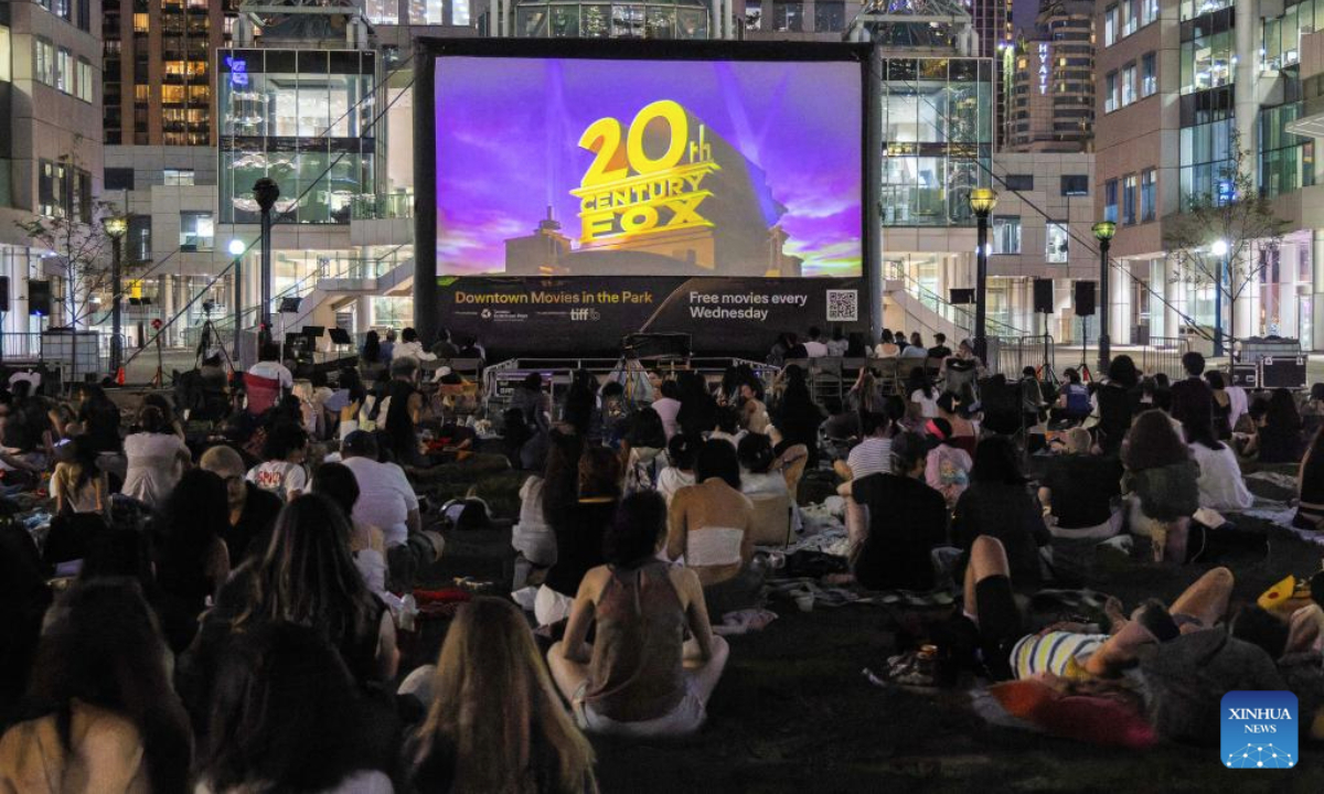 People watch an outdoor film screening during the Downtown Movies in the Park event at David Pecaut Square in Toronto, Canada, on July 16, 2025. Free outdoor screening is scheduled here on every Wednesday evening from July 9 to Aug. 13. (Photo by Zou Zheng/Xinhua)