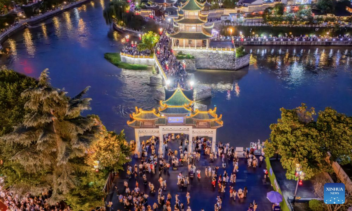 An aerial drone photo taken on July 30, 2025 shows people visiting Jiaxiu tower scenic area in Guiyang, capital of southwest China's Guizhou Province. Guizhou Province, with its cool climate and rich tourism resources, attracts tourists from all over the country during the peak summer travel season. (Xinhua/Liu Xu)