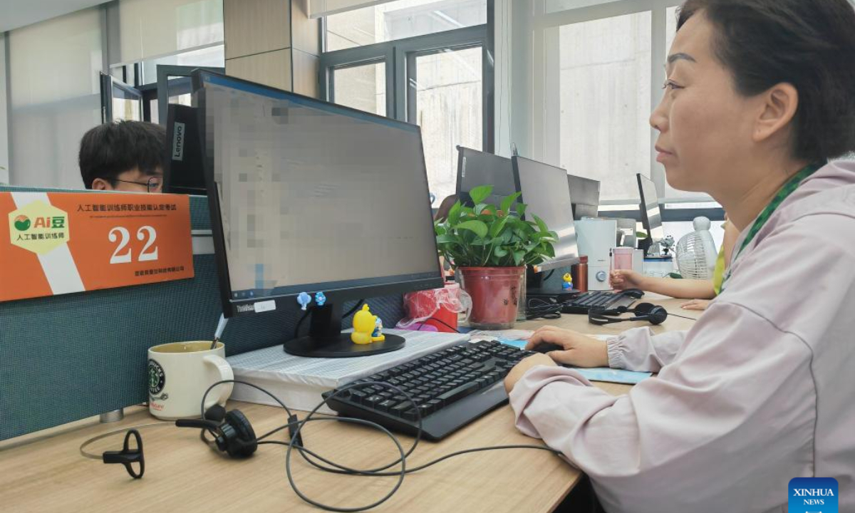 Wang Meimei works on artificial intelligence (AI) training at Aidou Technology Co., Ltd., in Yijun County, Tongchuan City of northwest China's Shaanxi Province, June 12, 2025. (Xinhua/Sun Zhenghao)