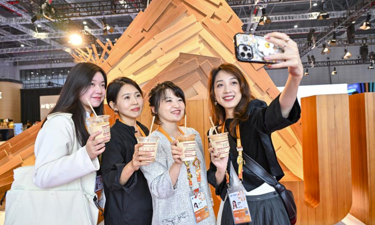 People take selfies at consumer goods exhibition area of the 7th China International Import Expo (CIIE) in east China's Shanghai, Nov. 7, 2024. (Xinhua/Zhang Cheng)