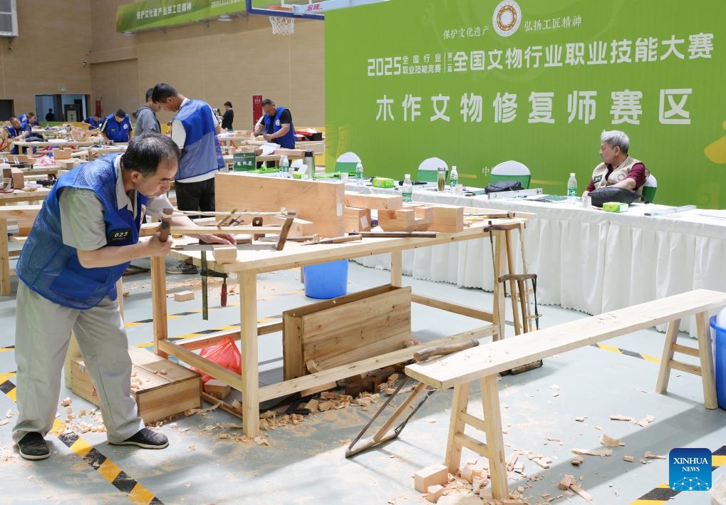 Contestants compete in woodwork relic restoration during the 2nd National Cultural Heritage Vocational Skills Competition in Luzhou City, southwest China's Sichuan Province, July 4, 2025. Starting from July 3, the four-day event attracted nearly 300 contestants competing in six categories. (Photo: Xinhua)