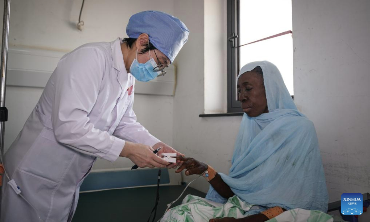 Zhao Weiwei, a doctor with the 35th Chinese medical team to Mauritania, examines an in-patient at the National Hospital in Nouakchott, Mauritania, on July 14, 2025. Since 1968, China has sent 35 batches of medical teams to Mauritania with more than 800 medical workers involved. The 35th Chinese medical team, consisting of 21 members, arrived in Mauritania in May 2023. (Xinhua/Han Xu)