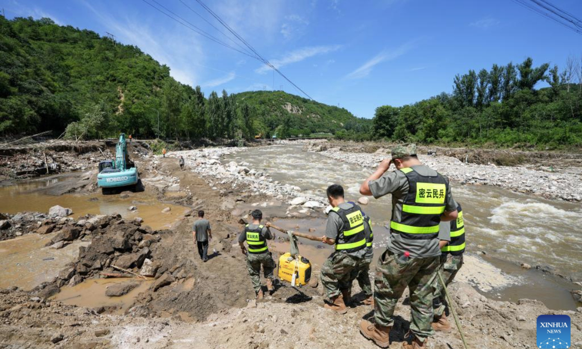Rescuers deliver relief supplies on foot to road-blocked villages in Fengjiayu Town, Miyun District of Beijing, capital of China, July 30, 2025. Due to continuous heavy rainfall in recent days, hundreds of villages in multiple districts of Beijing have been affected. In some villages of Fengjiayu Town, Miyun District, the roads have not yet been restored. Relevant departments have organized multiple rescue forces including firefighters and militiamen to transport relief supplies on foot to the villages to ensure the living needs of the affected villagers. (Xinhua/Ju Huanzong)