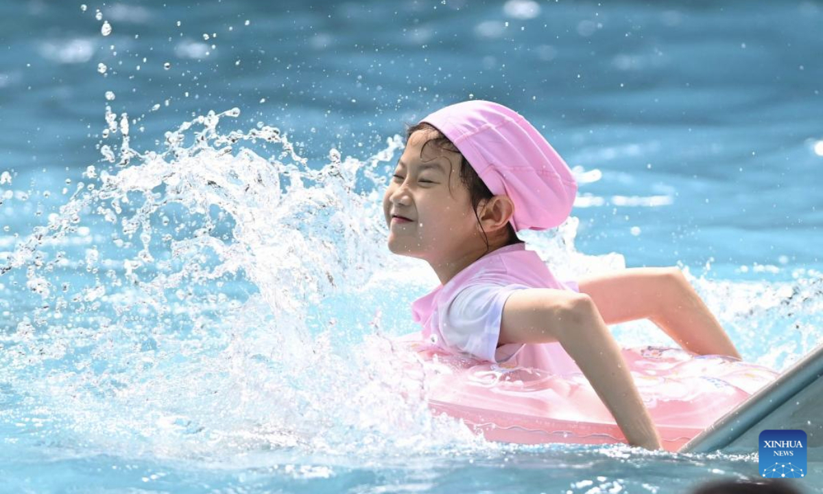 A girl enjoys herself in water at a water world in Zaozhuang City, east China's Shandong Province, July 12, 2025. High temperature during the summer vacation has triggered new vitality of cooling economy across the country. (Photo by Li Zhijun/Xinhua)
