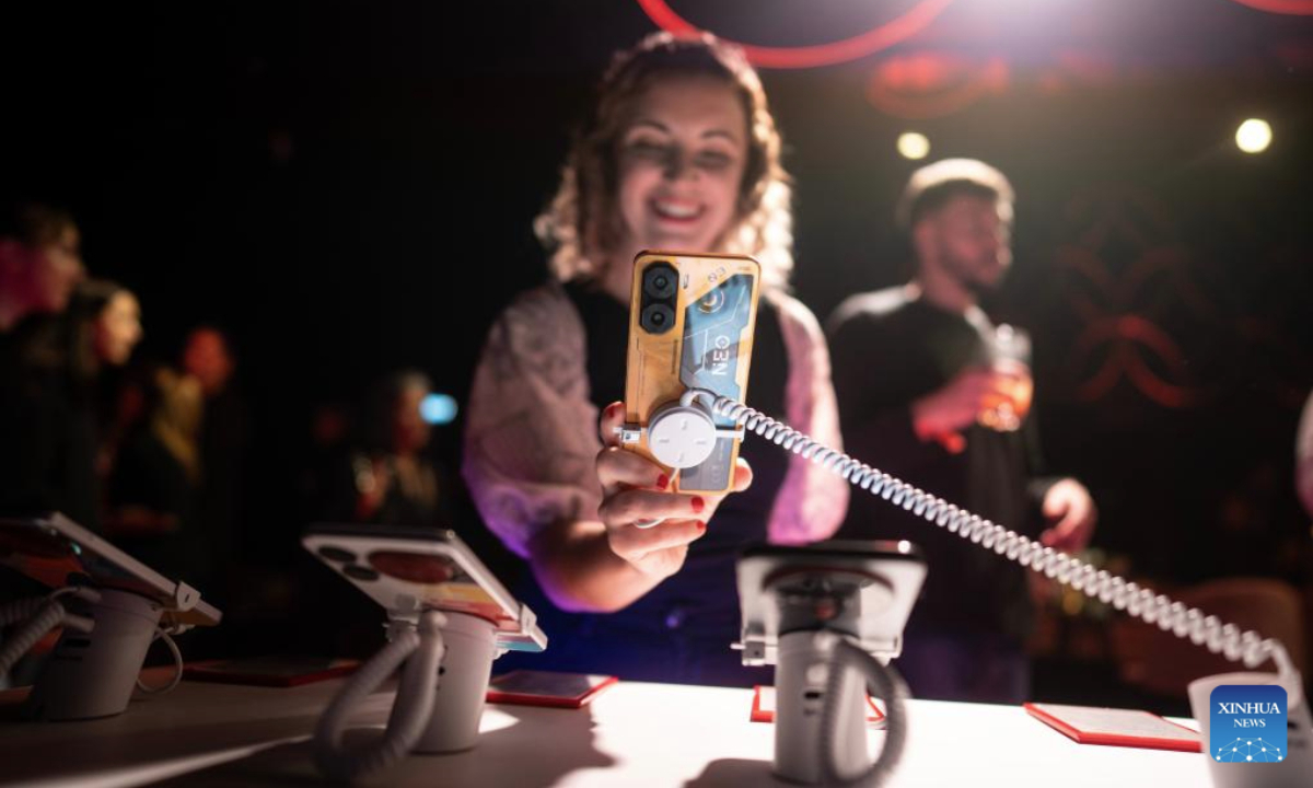 A woman tries out a Nubia smartphone in Buenos Aires, Argentina, on July 15, 2025. Chinese tech company ZTE held a product launch event in Buenos Aires on Tuesday, unveiling 10 new Nubia-branded devices, including smartphones. According to the company, all the new products are assembled in Río Grande, Tierra del Fuego Province, and became available nationwide in Argentina starting July 16. (Photo by Martin Zabala/Xinhua)