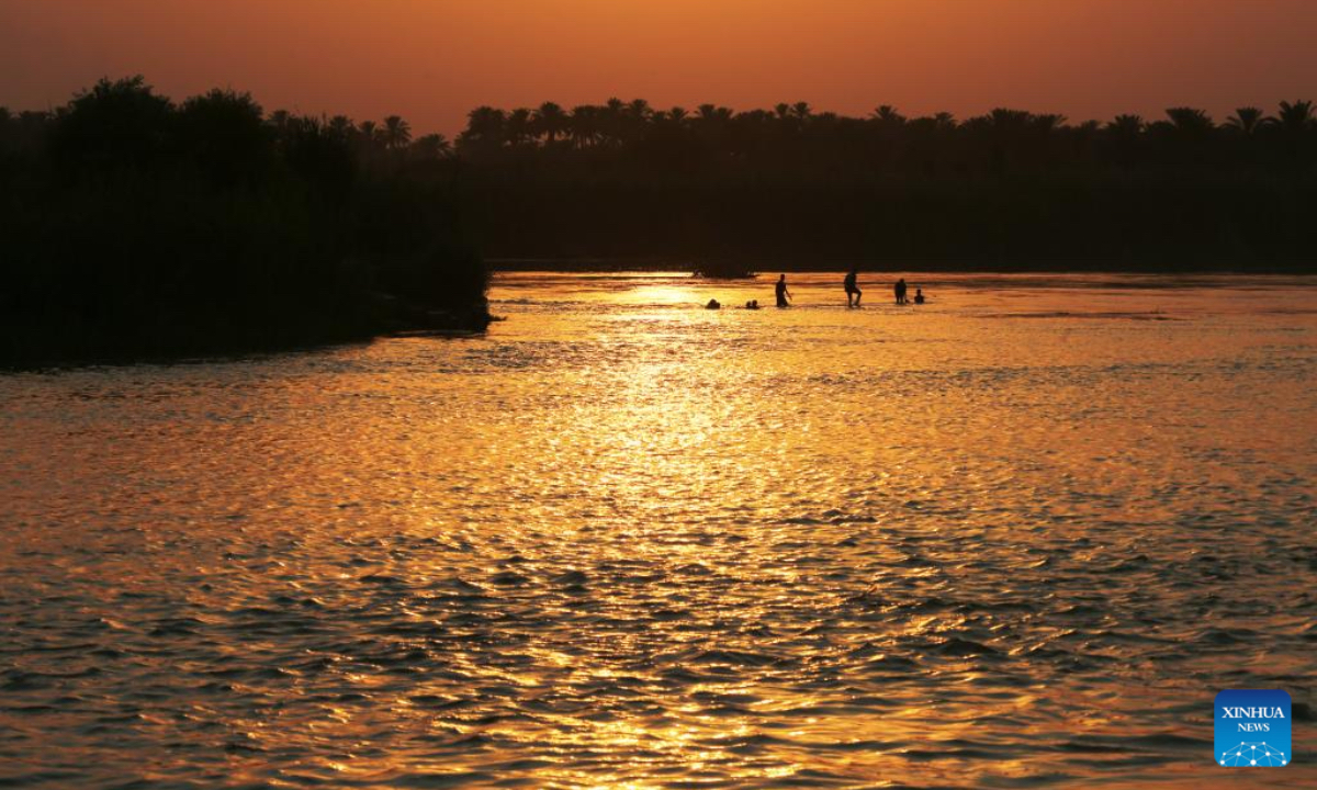 People enjoy swimming in the Tigris River in Baghdad, Iraq at sunset time on July 11, 2025. (Xinhua/Khalil Dawood)