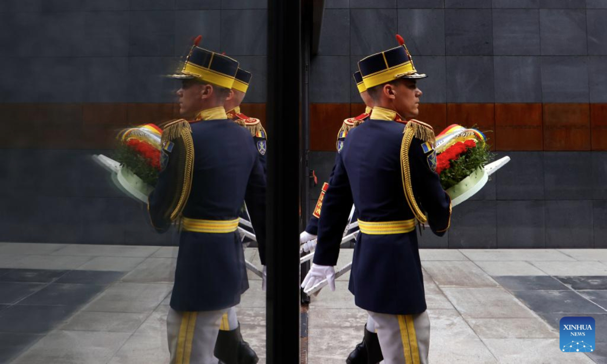 Romanian soldiers carry a wreath during ceremonies marking the European Roma Holocaust Memorial Day at a Holocaust memorial in Bucharest, Romania, July 31, 2025. (Photo by Cristian Cristel/Xinhua)