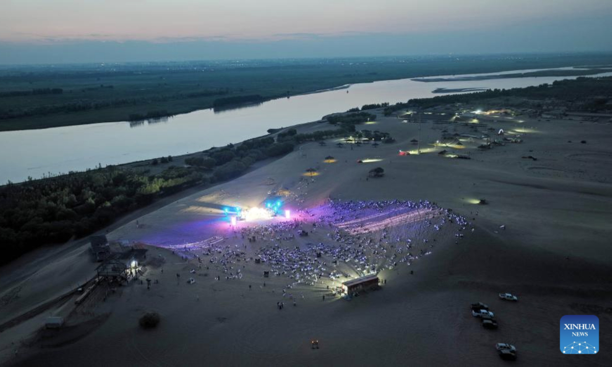 An aerial drone photo taken on July 13, 2025 shows people enjoying a performance at a scenic area in Yinchuan, northwest China's Ningxia Hui Autonomous Region. (Xinhua/Wang Peng)