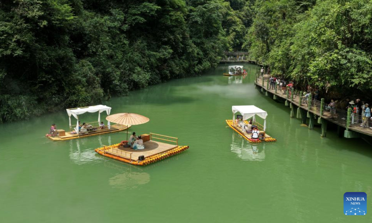 Tourists take boats enjoying the view of Pingshan canyon in Hefeng County, Enshi Tujia and Miao Autonomous Prefecture, central China's Hubei Province, July 9, 2025. The unique canyon landscape and limpid water make the Pingshan Canyon an attractive destination for tourists. (Photo by Yang Shunpi/Xinhua)