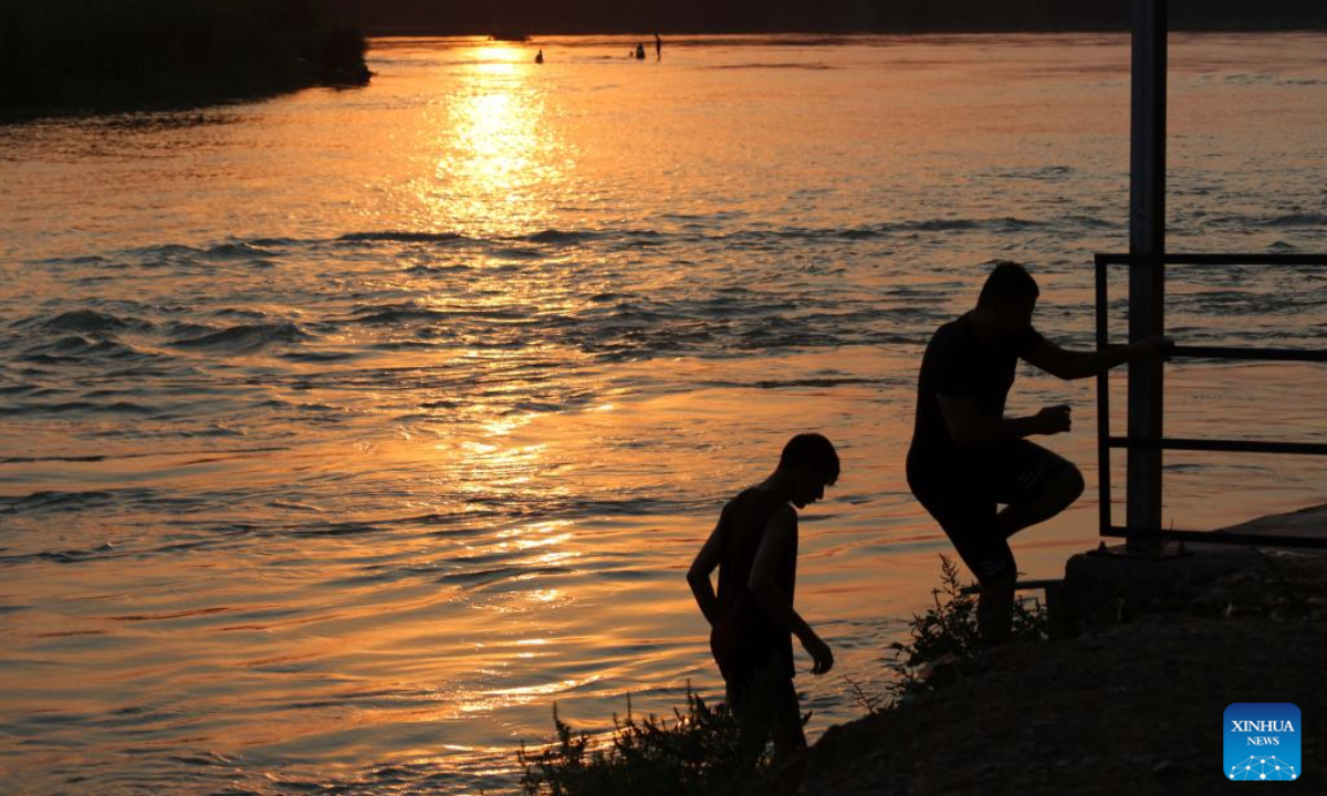 People enjoy swimming in the Tigris River in Baghdad, Iraq at sunset time on July 11, 2025. (Xinhua/Khalil Dawood)