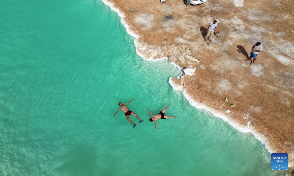 An aerial drone photo taken on July 28, 2025 shows tourists floating on a salt lake at Siwa Oasis in Matrouh Governorate, Egypt. Siwa Oasis lies in Egypt's western desert, some 800 kilometers from Cairo. There are many natural salt lakes on which people can float with no effort due to high salt concentration. (Xinhua/Ahmed Gomaa)