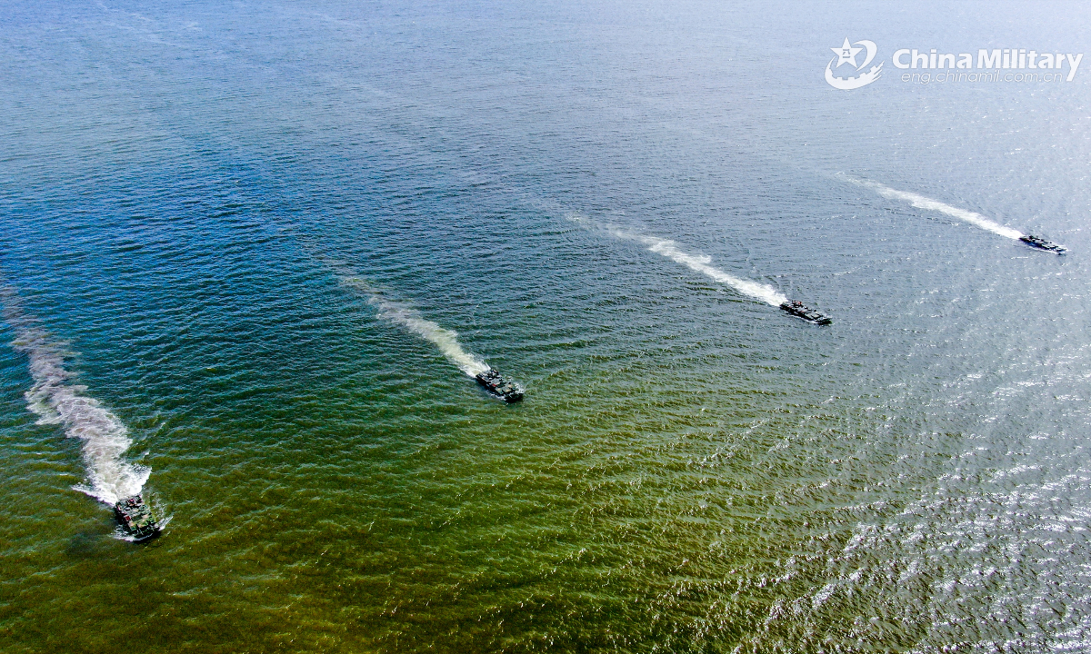 Amphibious armored infantry fighting vehicles (IFV) attached to a brigade with the Chinese PLA Army maneuver towards the designated area during a ferrying and assault wave formation training exercise on July 6, 2025. (eng.chinamil.com.cn/Photo by Zhang Mao)